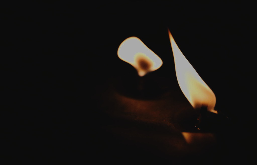A candle flickering in the darkness.