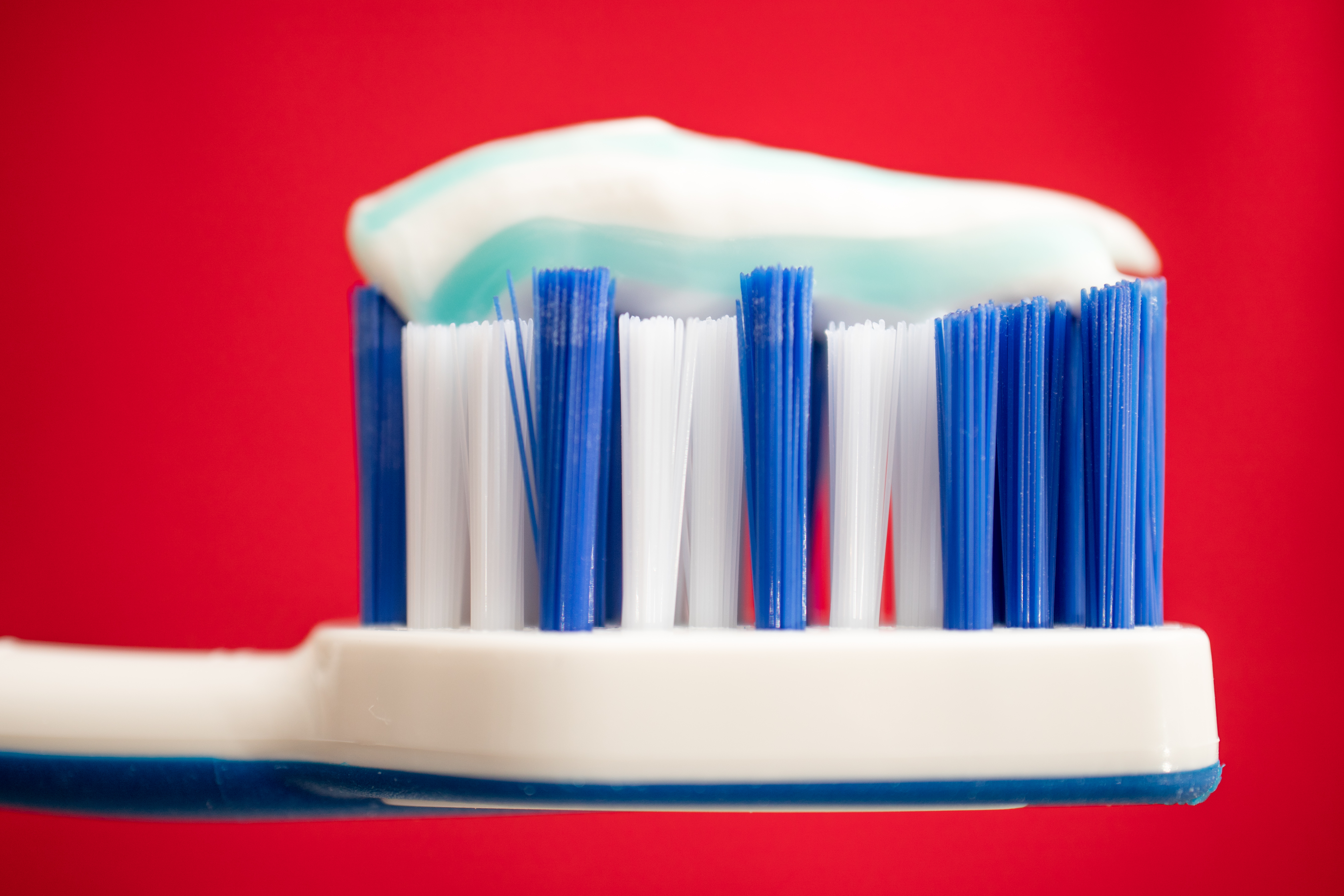 A close-up image of a toothbrush and toothpaste.