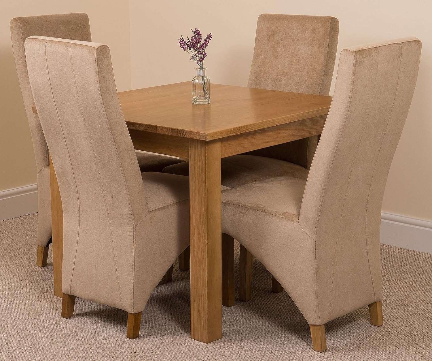 A dining table set for two with an empty chair.