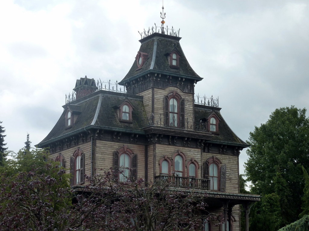 A haunted house with a person entering it.
