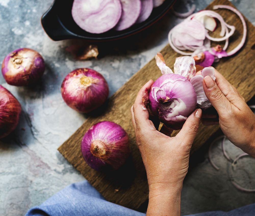 A person peeling an onion.