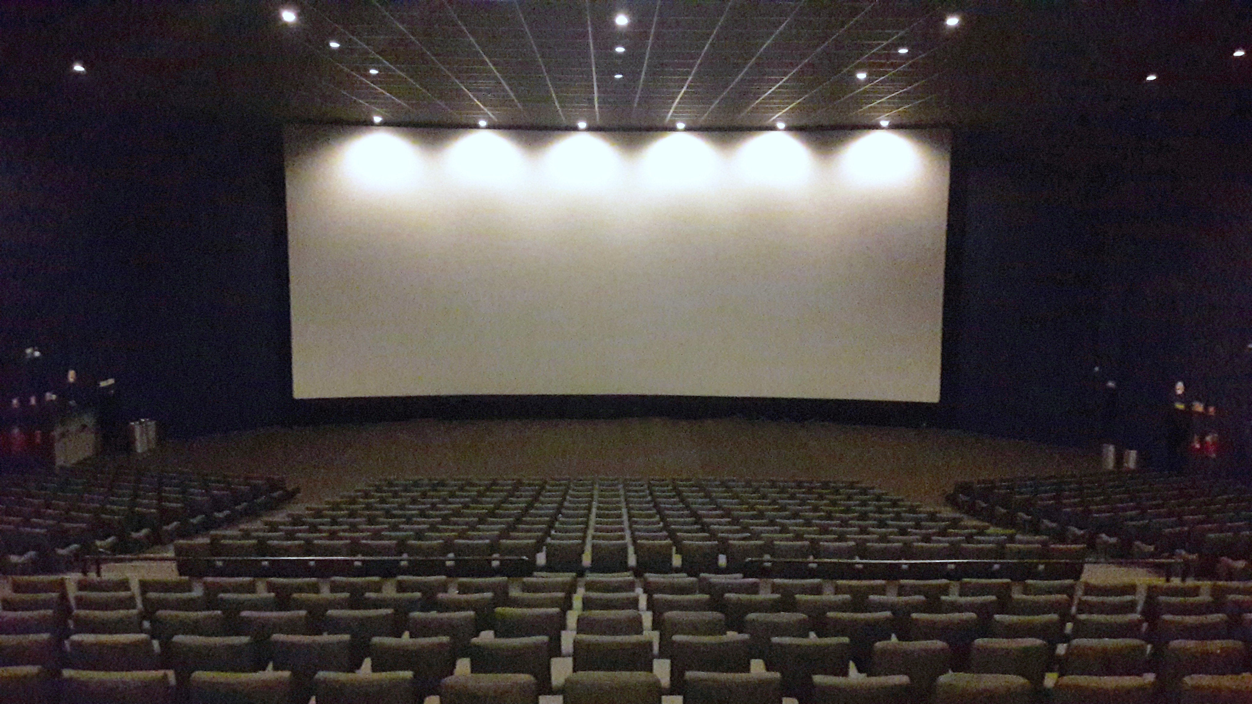A person standing alone in an empty theater.