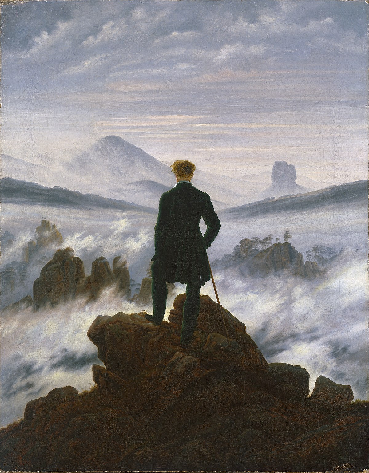 A person standing on a clifftop overlooking a vast and unknown landscape.