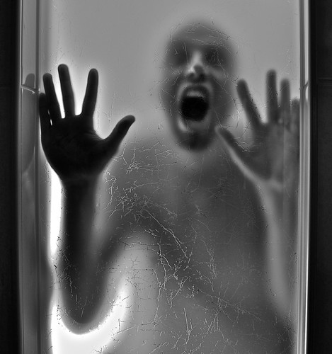 A person trapped inside a small, closed room.