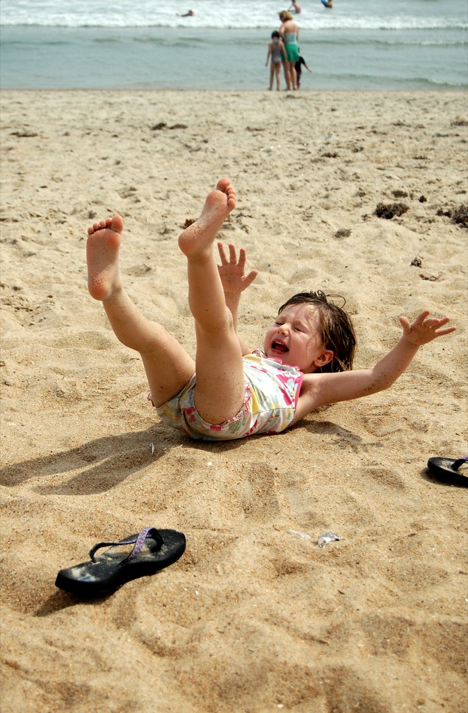 A person with their mouth filled with sand.