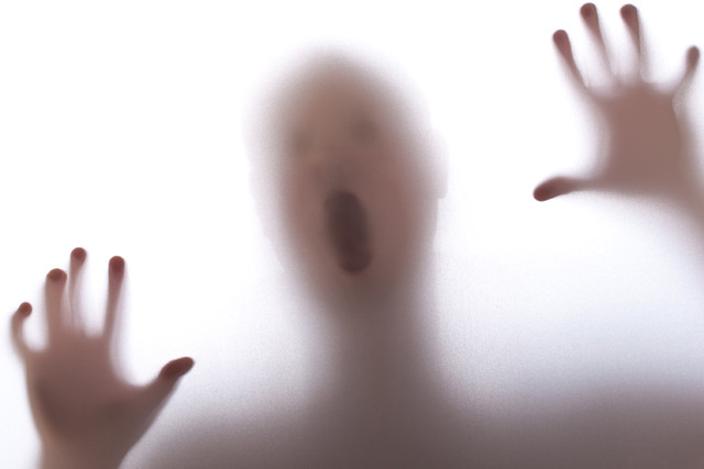 A picture of a person having a conversation with a ghostly figure representing a deceased mother.
