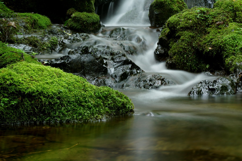 A river flowing with a person dreaming above it.