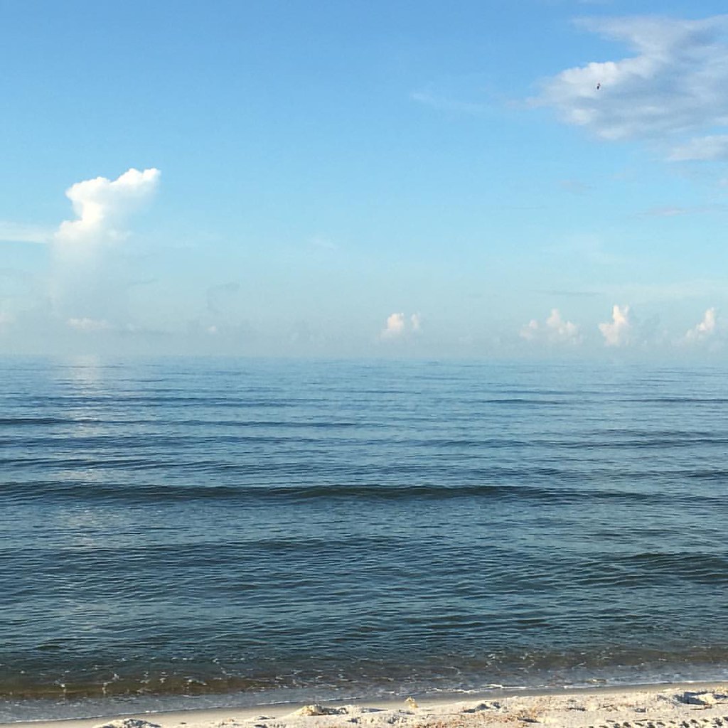 A serene image of a peaceful blue ocean.