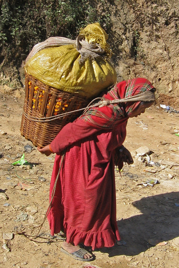 An image of a person carrying a heavy burden.