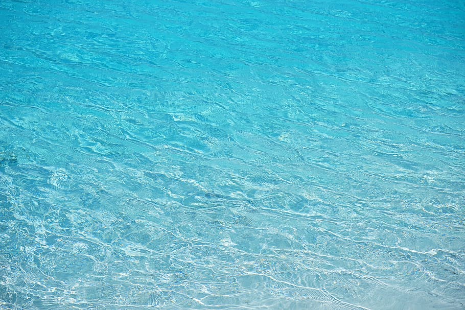 Clear blue water with a person submerged or diving.