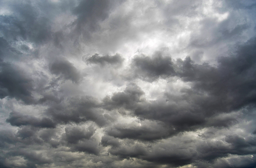 Cloudy sky with a person deep in thought