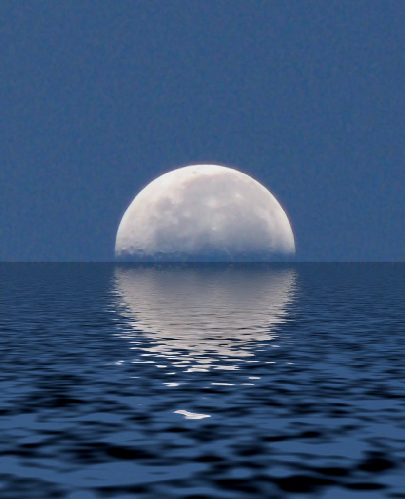 Full moon reflecting on calm water